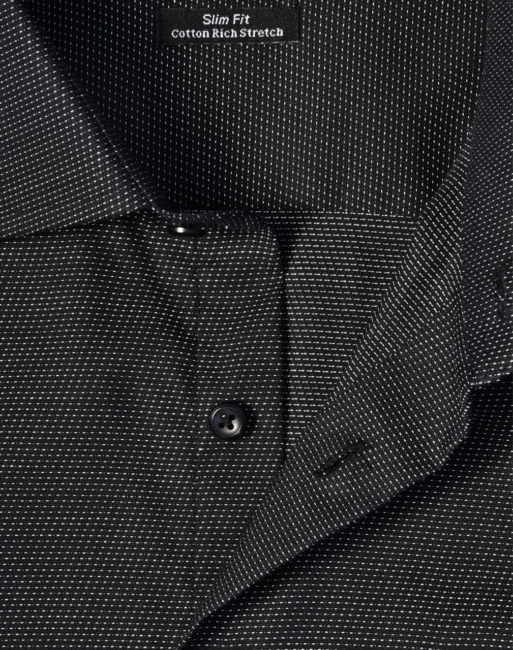 A close-up of a men's black pin dot stretch short-sleeve shirt featuring a slim fit and a collar with buttons.