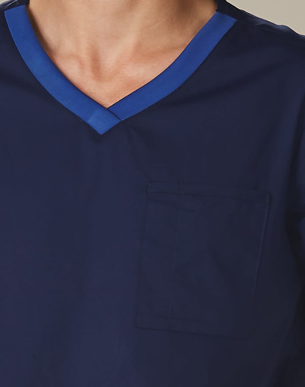 Men's short-sleeve scrub top in navy, featuring a contrast blue neckline and a front pocket. Includes a logo.