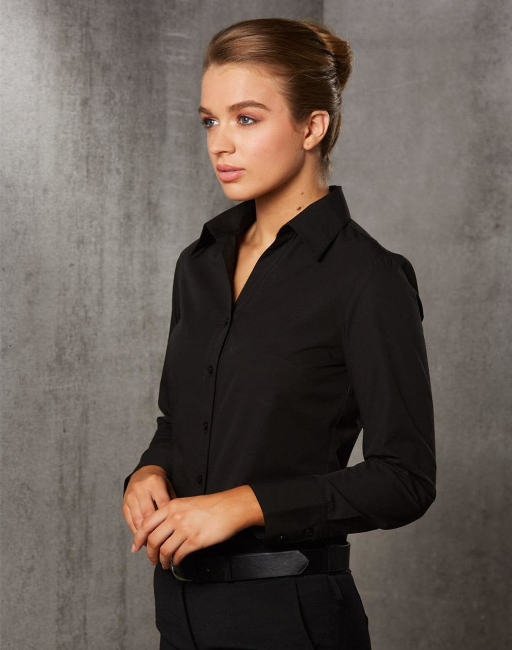 A black long sleeve button-up shirt for women, featuring a fitted design and a collar.