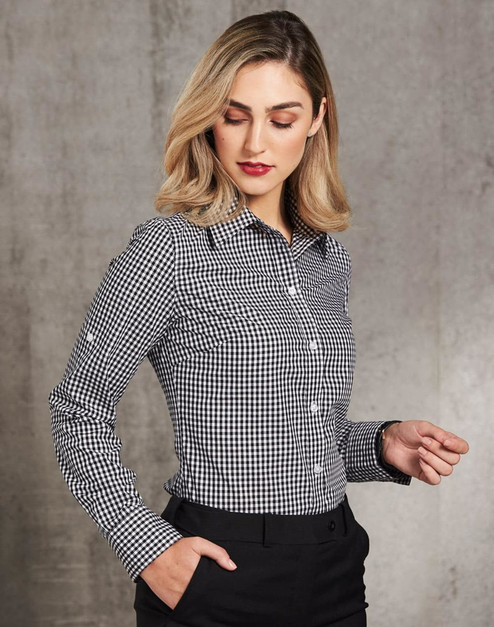 A women's long-sleeve button-up shirt featuring a black and white gingham check pattern, with a logo.