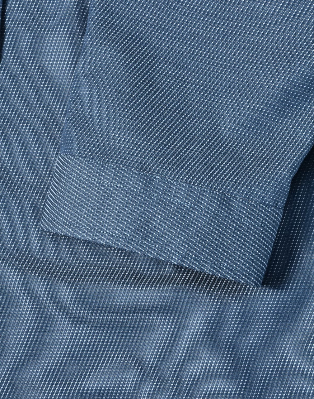 A blue pin dot stretch shirt featuring a 3/4 sleeve and folded cuff detail. Includes a logo.