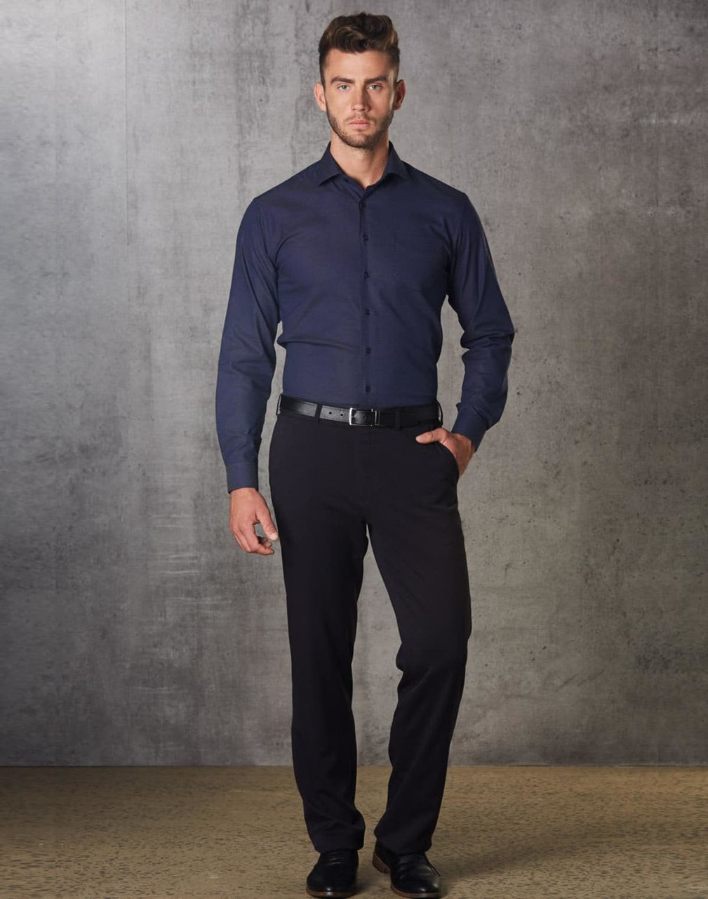 Men's polyviscose stretch pants in black, paired with a button-up shirt, displayed against a textured grey background.