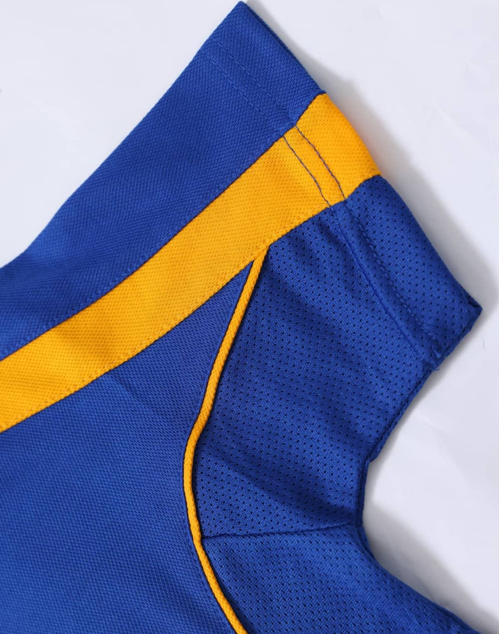 A blue polo shirt with yellow detailing and a breathable fabric. Features a logo on the chest area.