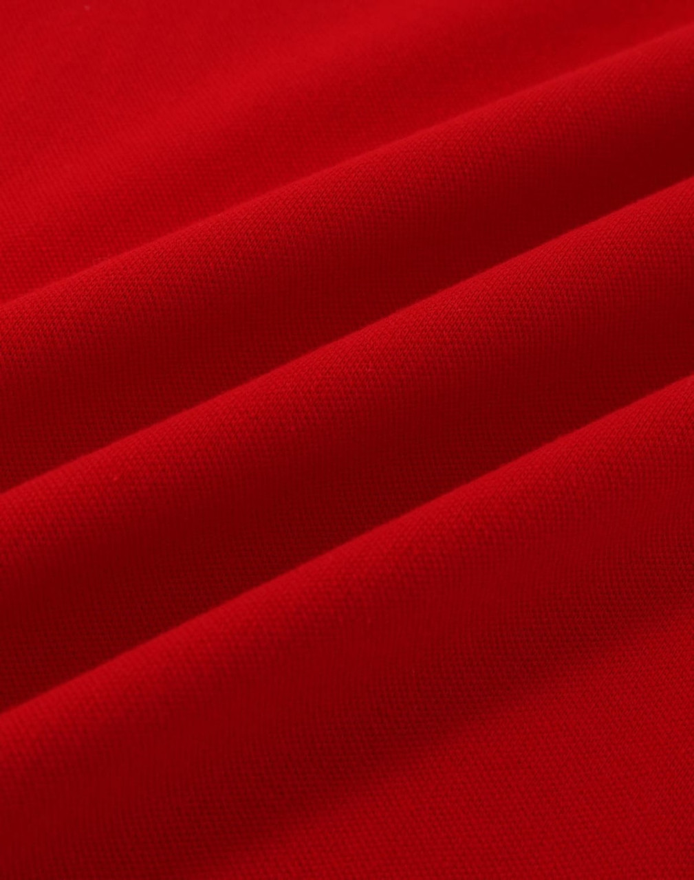 A vibrant red cotton stretch fabric with soft folds, suitable for polo shirts. Features a logo.
