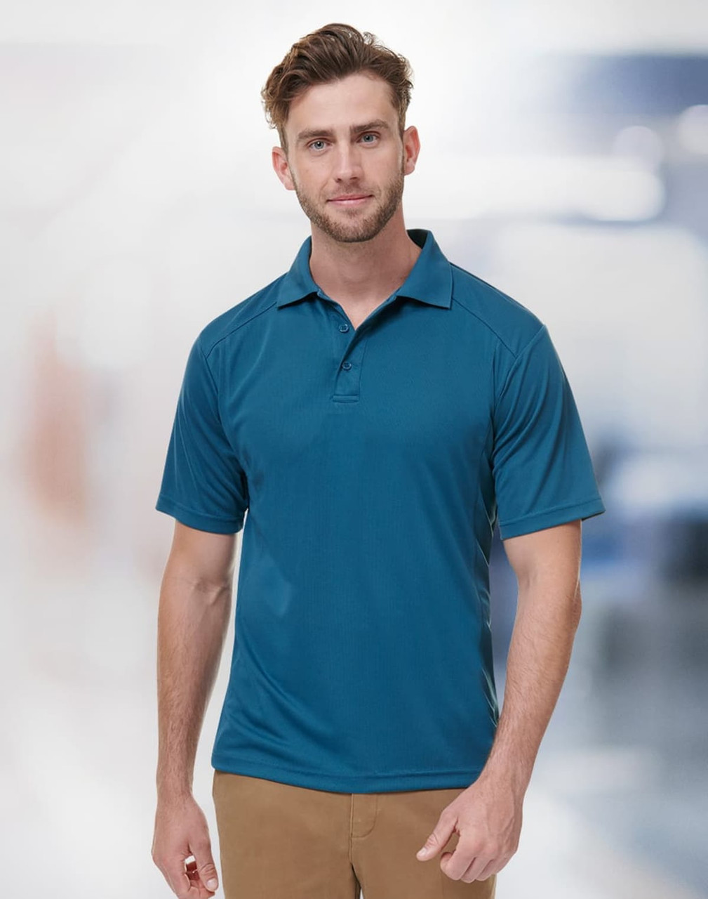A men's short-sleeve polo shirt in a vibrant blue colour, featuring a collar and an emblem.