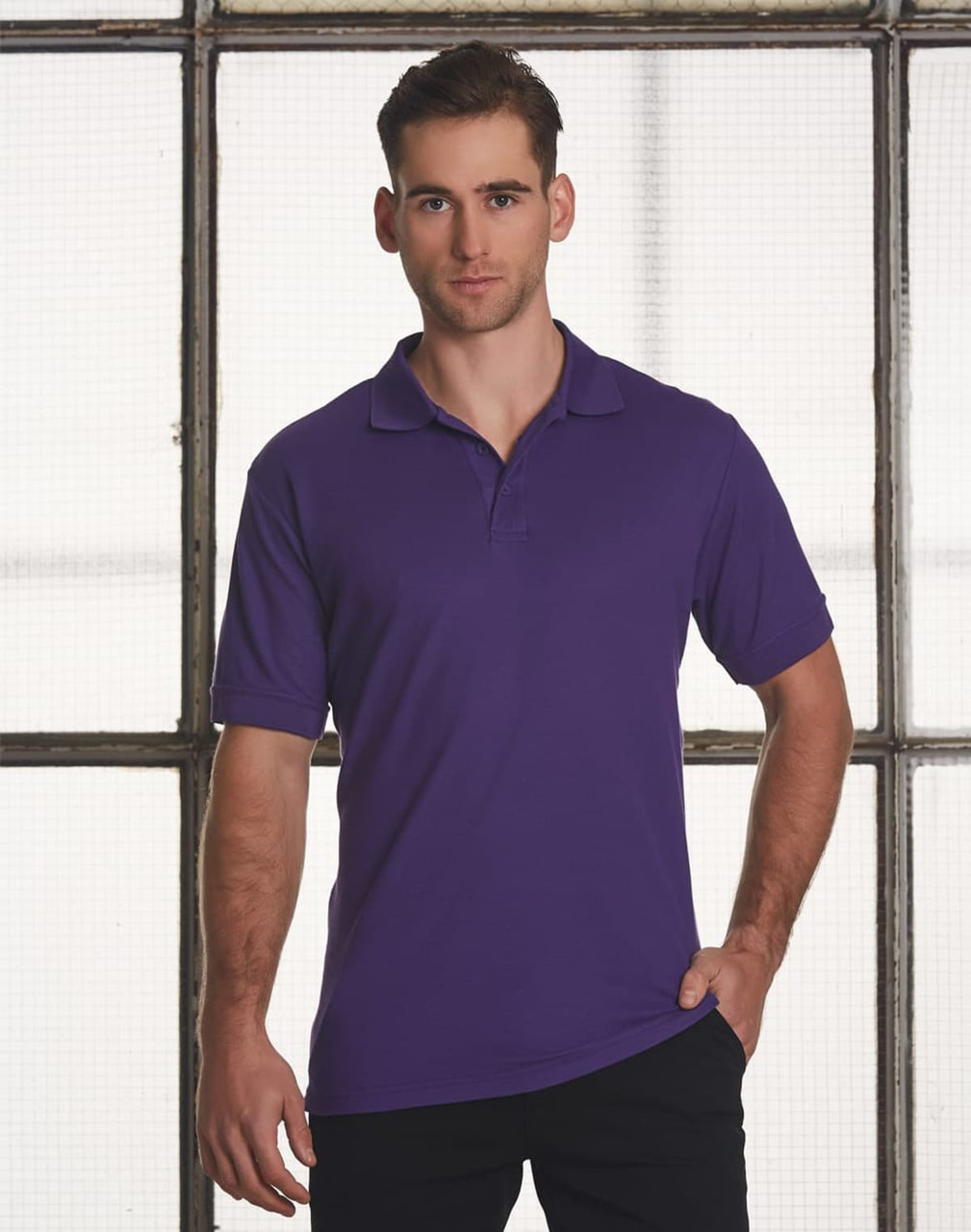 A purple men's polo shirt featuring short sleeves and a collar. The shirt has a logo on it.