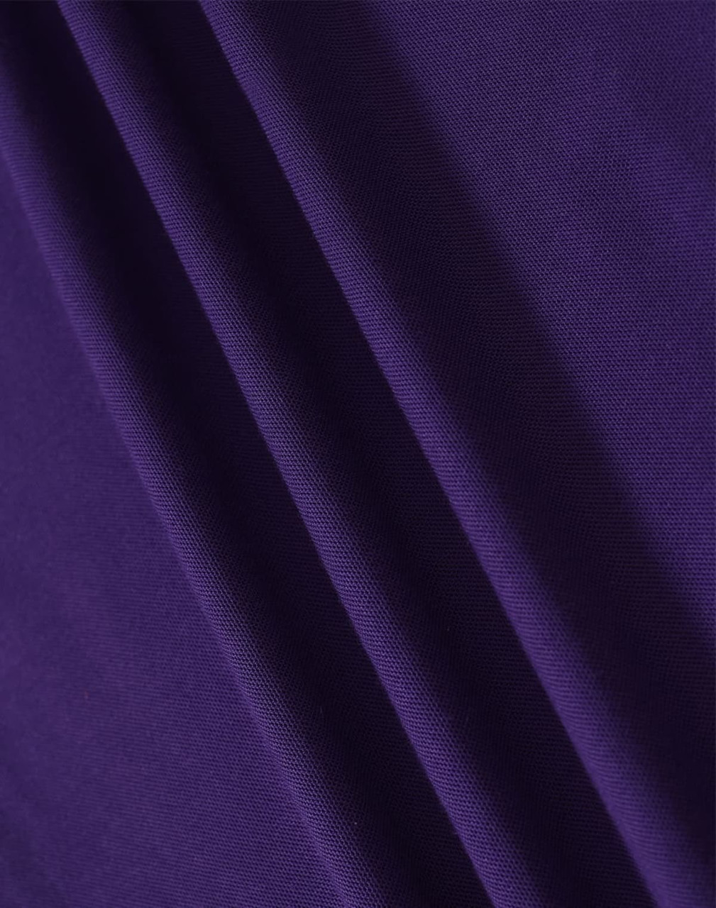 A close-up of fabric in a rich purple hue, showcasing the texture and depth of the material.