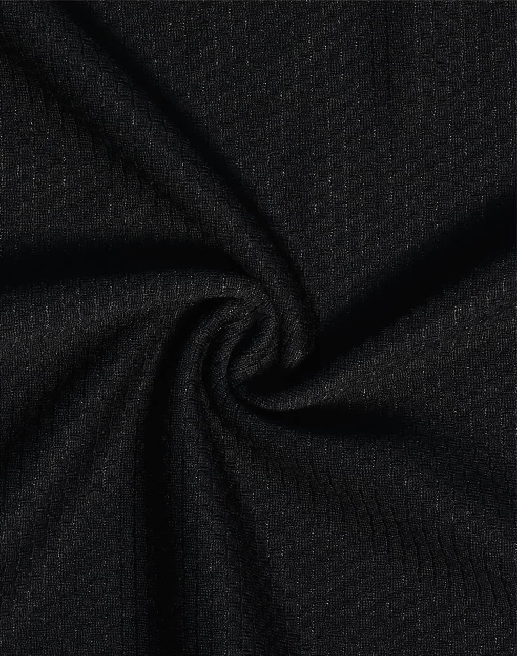 A close-up view of black textured fabric, showcasing a woven pattern suitable for polo shirts.