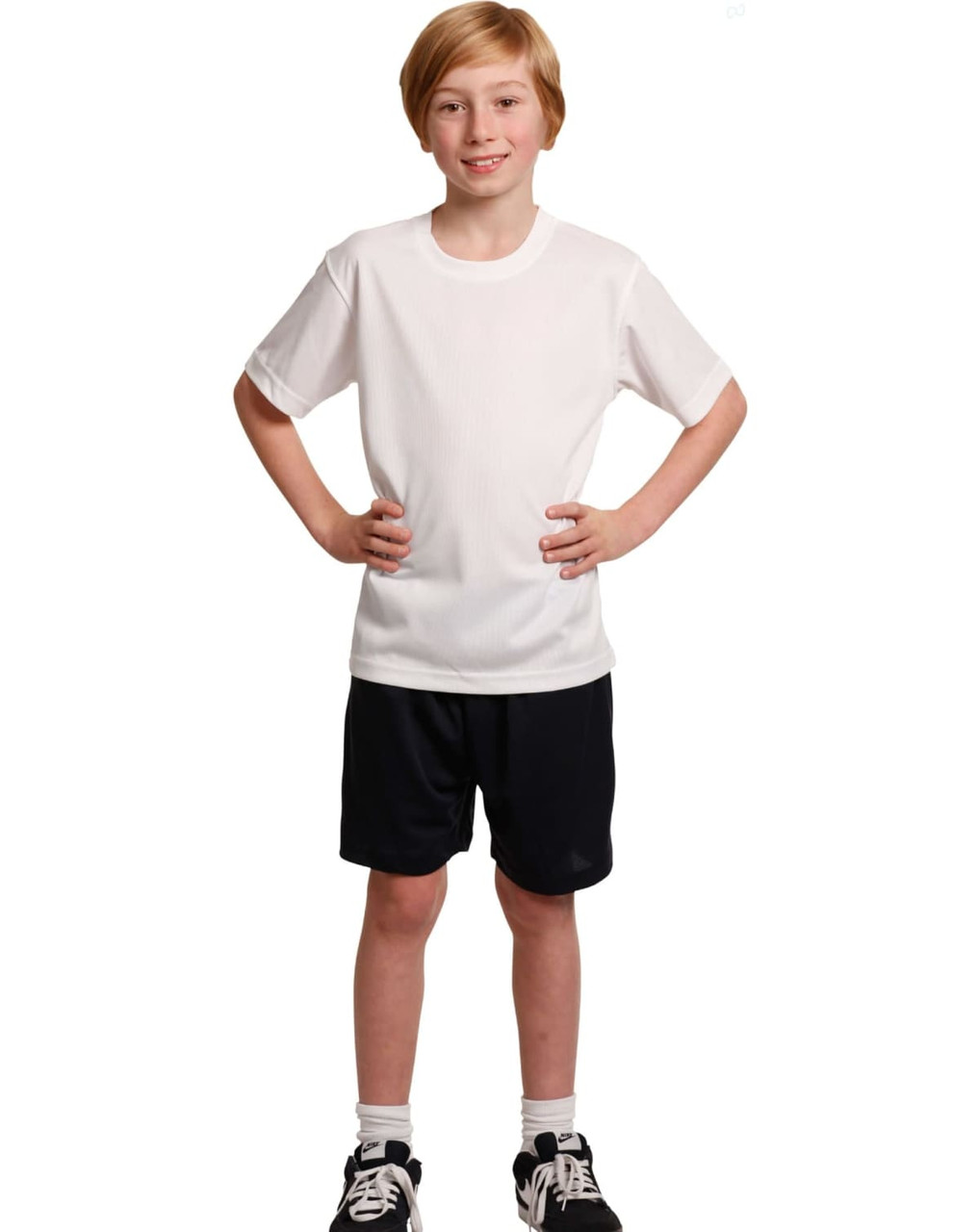 Kids cooldry sports shorts in black, paired with a white sports t-shirt. The outfit is modelled by a young boy.