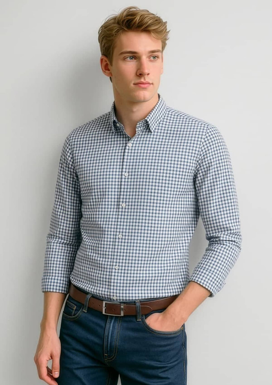 A long-sleeve button-up shirt featuring a navy and white check pattern, styled with a collar and rolled sleeves.
