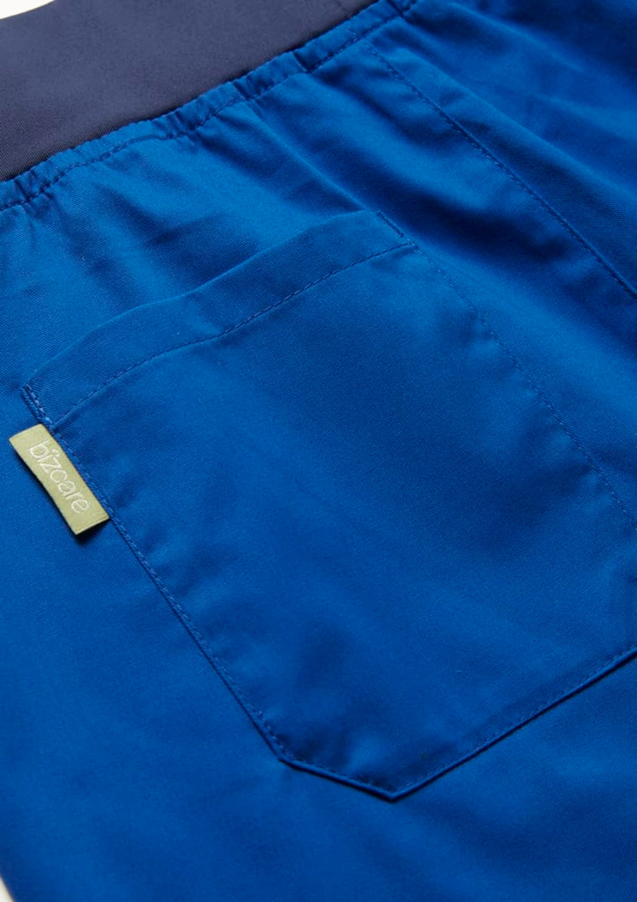 A close-up of blue women's jogger scrub pants featuring a back pocket and waistband. Includes a logo tag.