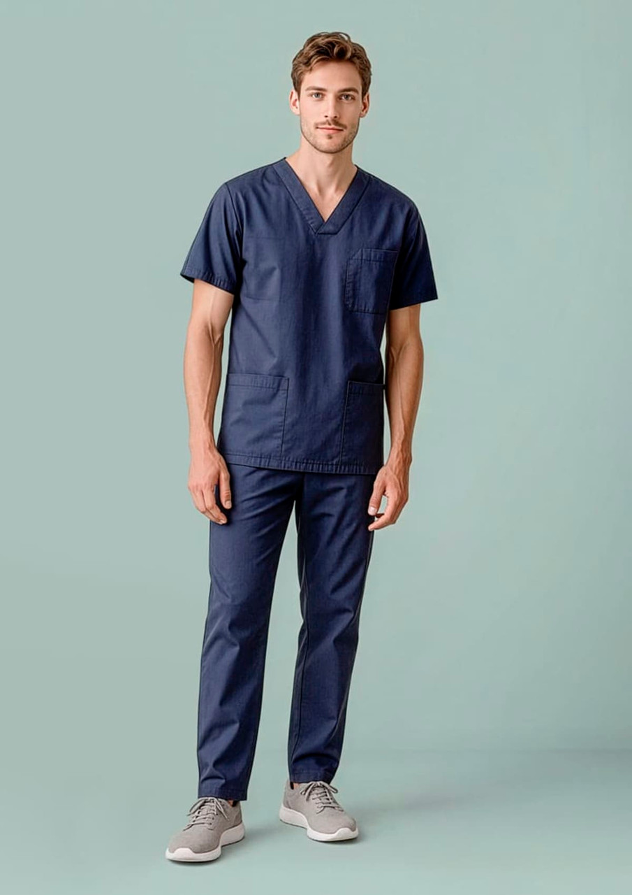 A unisex navy scrub top features a V-neck design and two pockets, worn by a model with matching scrub pants.