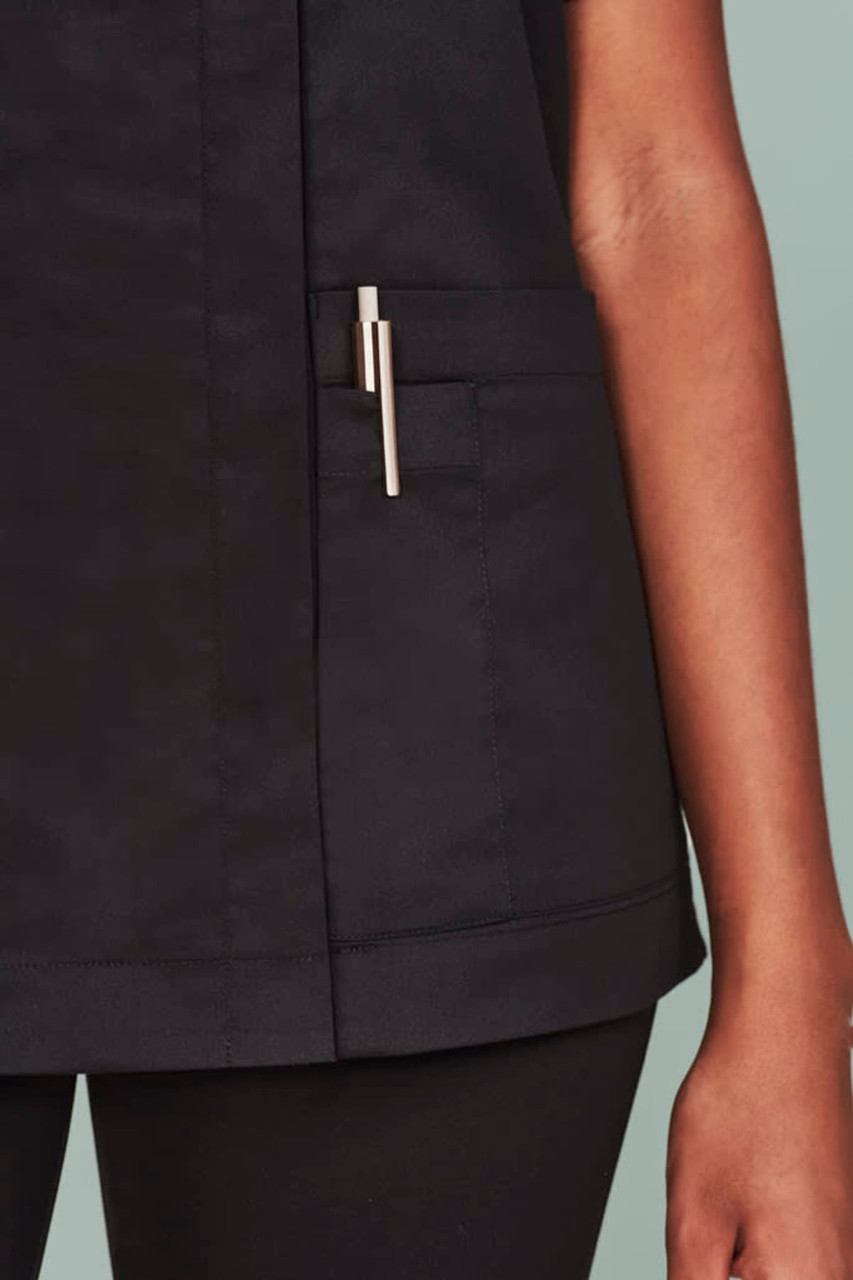 Black women's scrub top featuring a zip front and a side pocket with a pen holder.