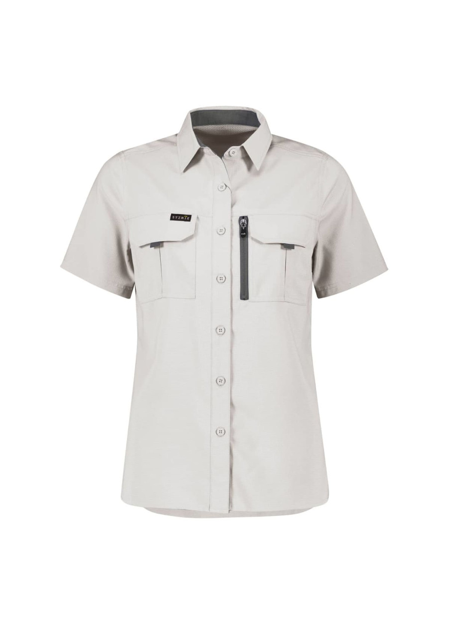 A women's short sleeve shirt in light grey with two front pockets and a zippered pocket, featuring a logo.