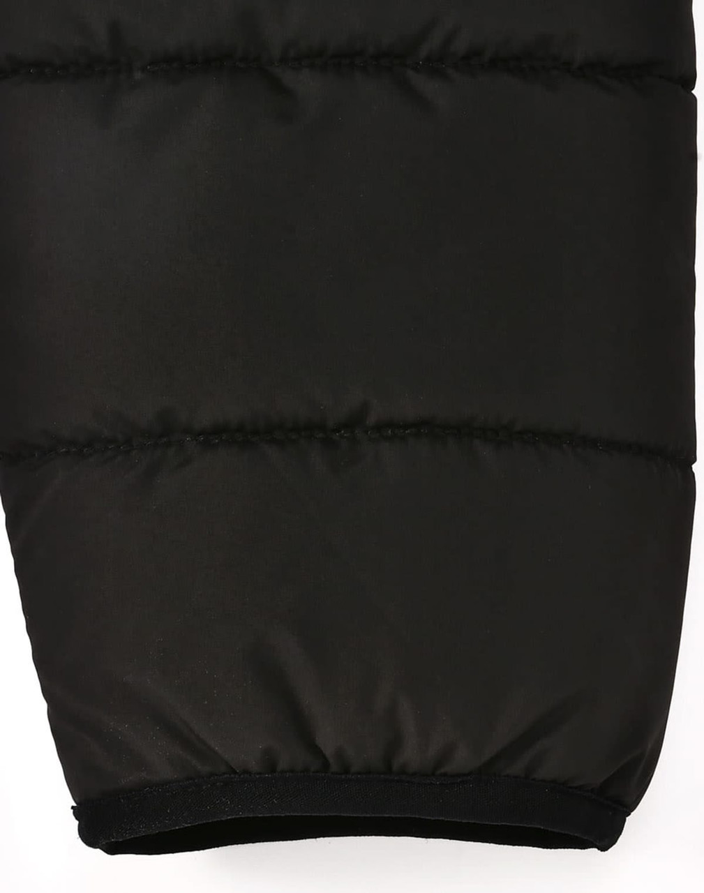 A black puffer jacket featuring a 3D cut with an elasticated hem, designed for insulation and sustainability.