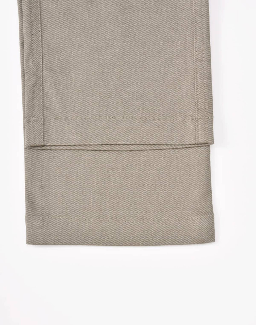 Unisex cotton stretch ripstop work pants in a light beige shade, showcasing a smooth, flat hem at the cuff.