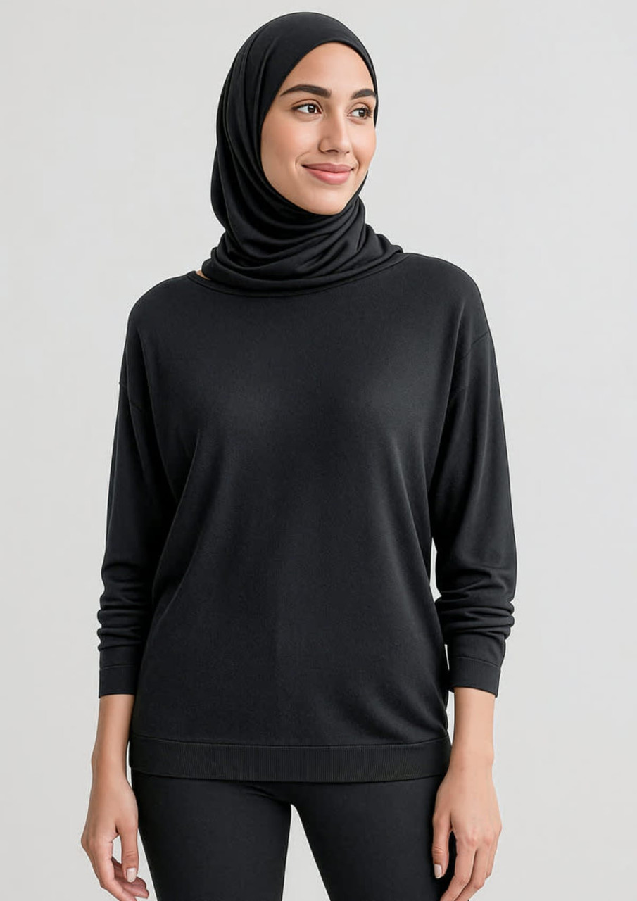 A black women's batwing sweater top, featuring a relaxed fit and long sleeves, worn with a matching headscarf.