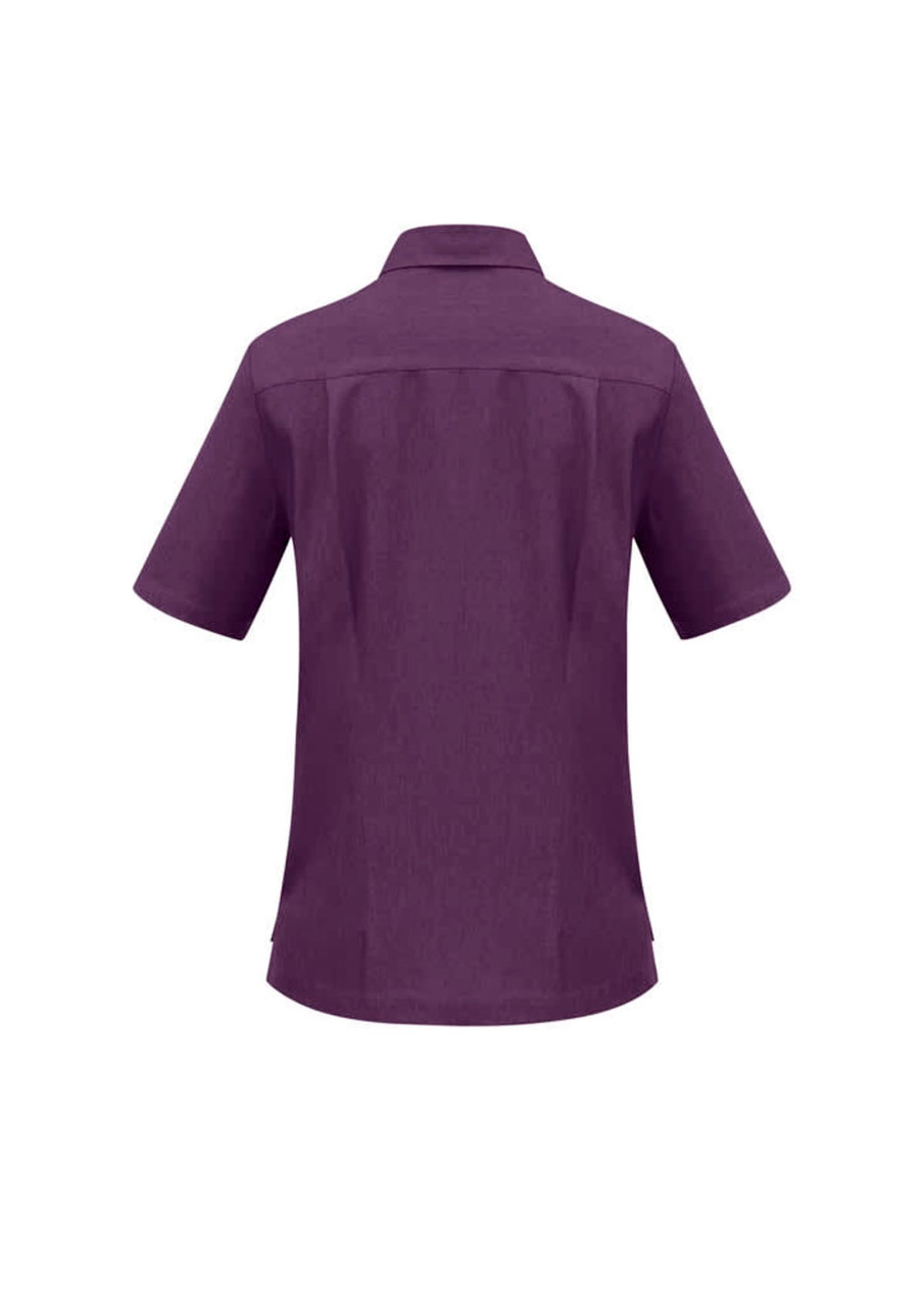 A purple overblouse with short sleeves and a collar, featuring a back yoke detail. It has a logo.