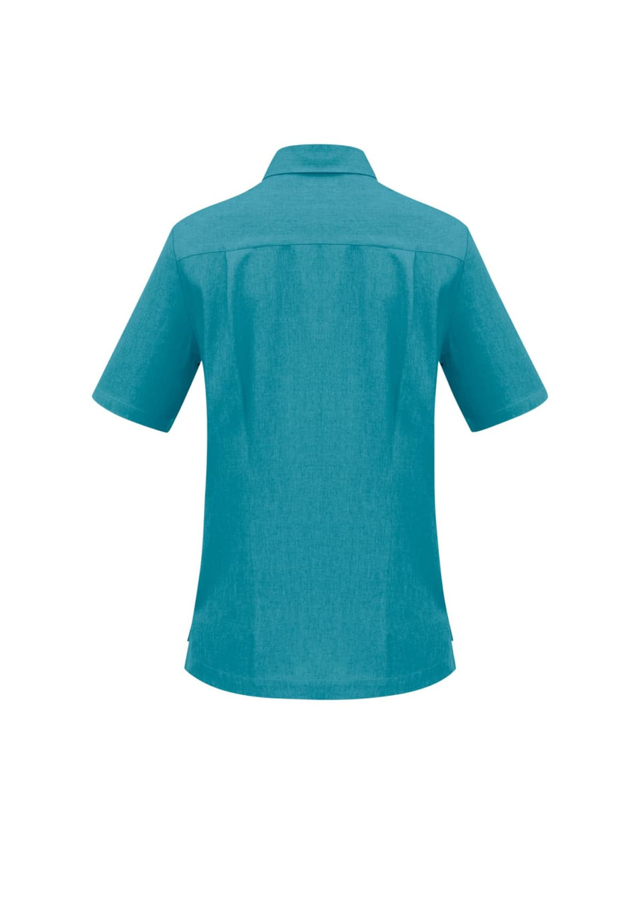 A turquoise women's overblouse with short sleeves and a collar, featuring a logo on the back.