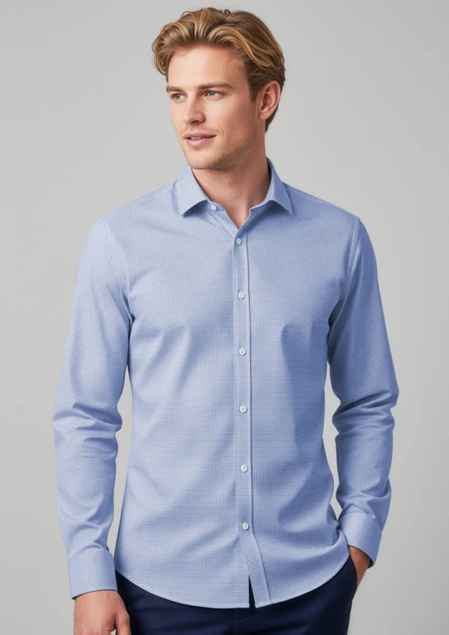A tailored long sleeve shirt in light blue, featuring a button-up front and a collar, modelled by a man.