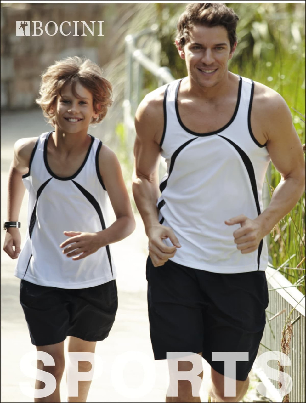 A man and a boy are jogging outdoors, wearing matching white and black athletic tank tops with shorts.