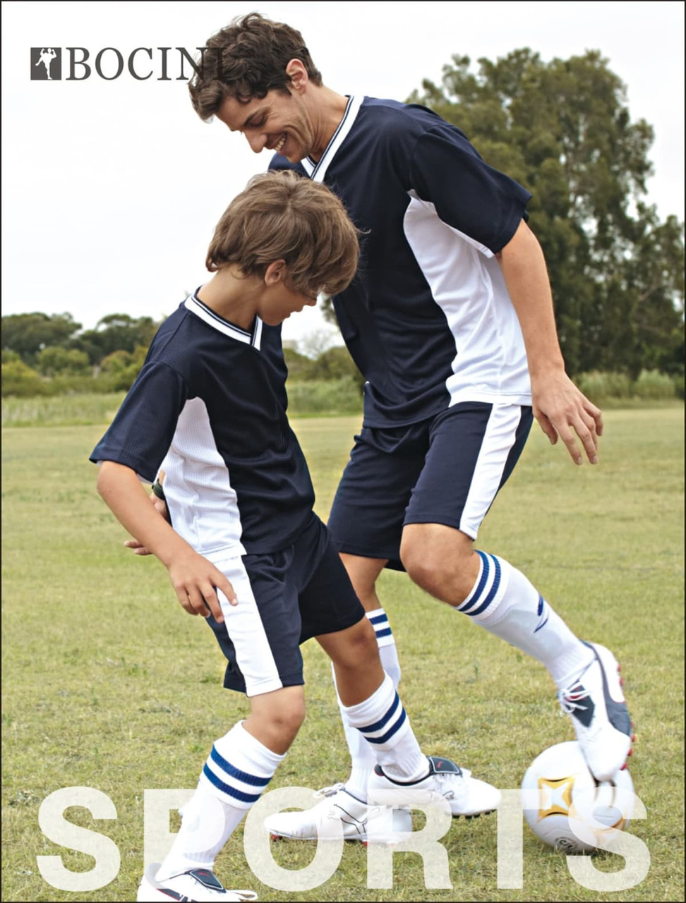 A pair of players wearing navy blue and white soccer shorts, enjoying a game on a grassy field.