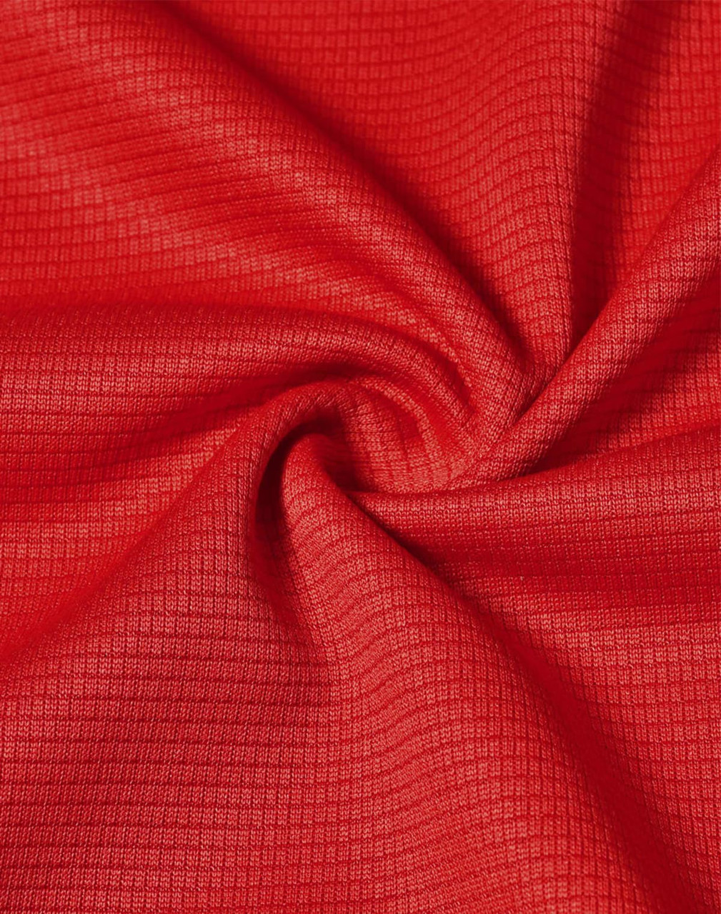 A close-up of red fabric with a textured, lightweight appearance suitable for performance wear.