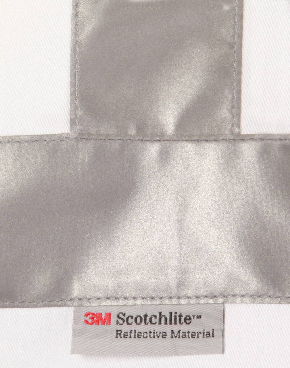 A reflective silver strip on a white fabric with a label for 3M Scotchlite reflective material.