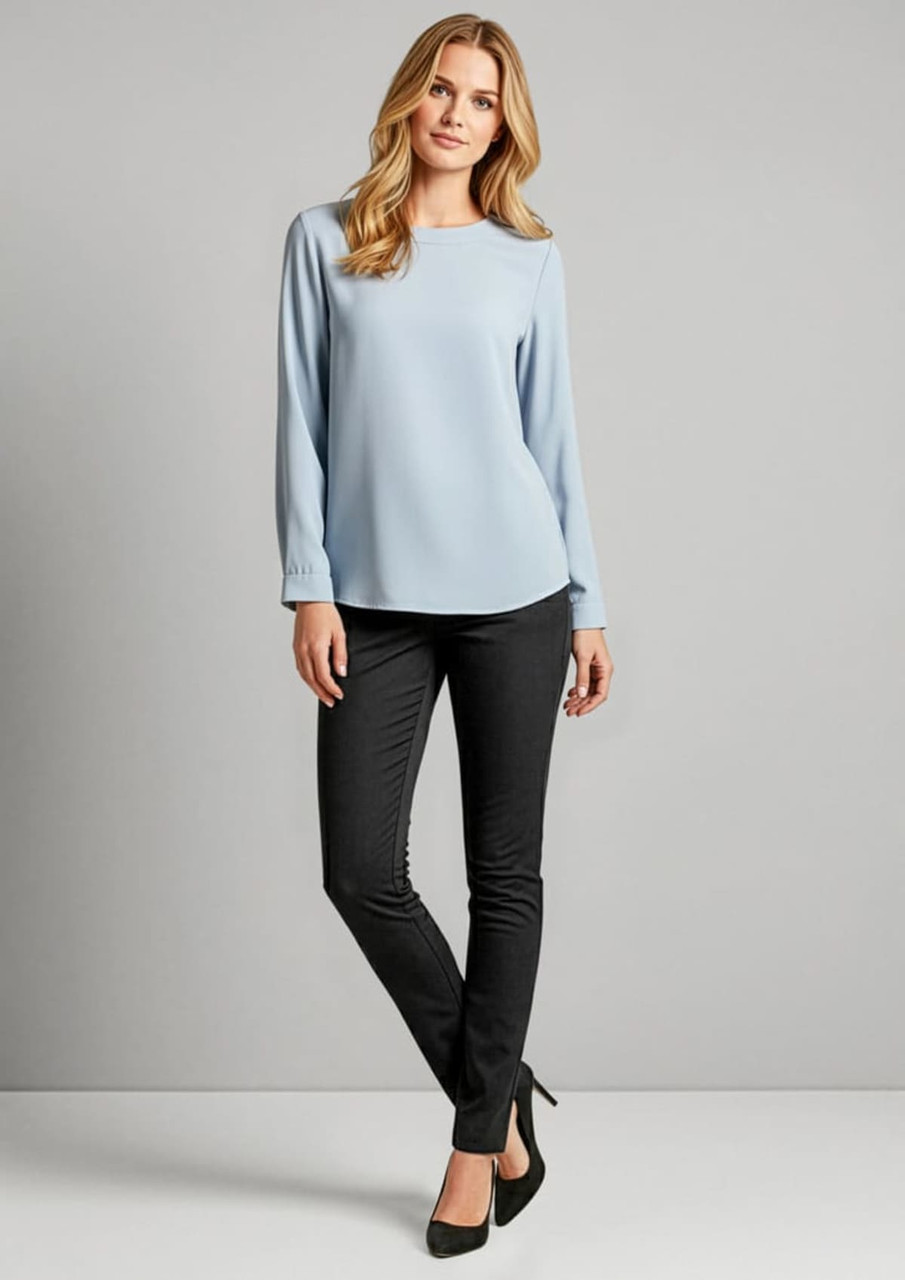 A model wears black leggings paired with a blue top and heels, standing against a neutral background.