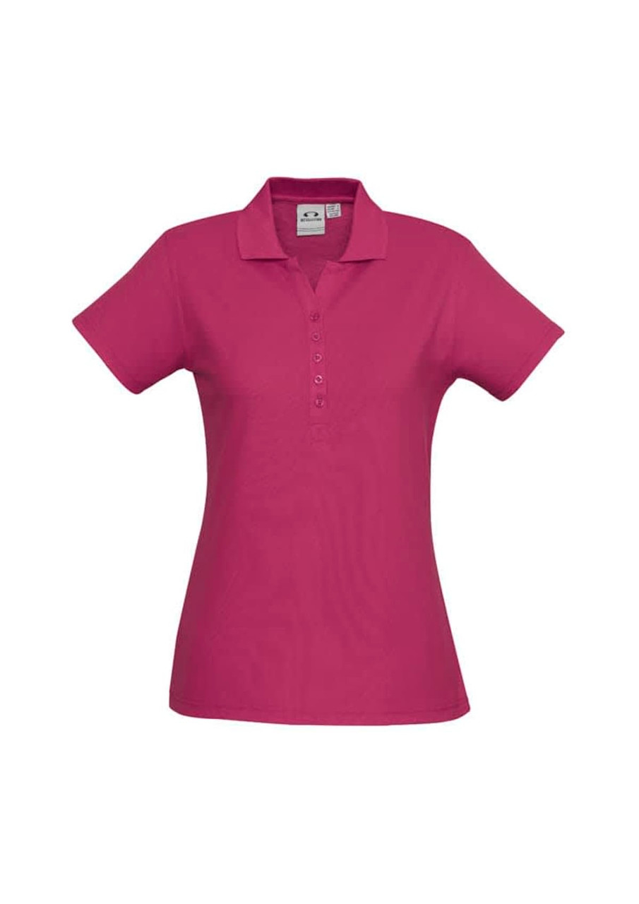 A pink ladies polo shirt with a classic collar, short sleeves, and a button placket. Features a logo on the front.
