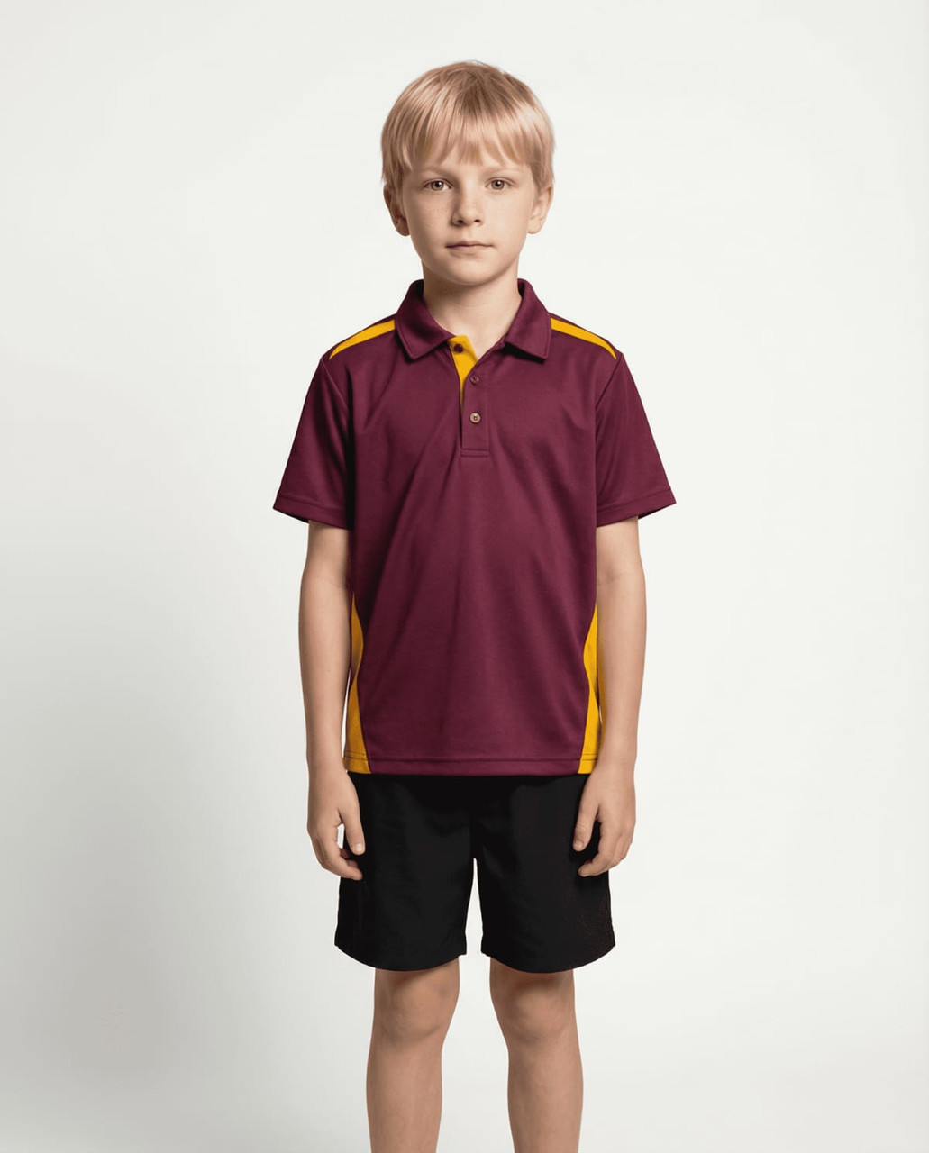 A child wearing a maroon and yellow polo shirt paired with black shorts, standing against a plain background.