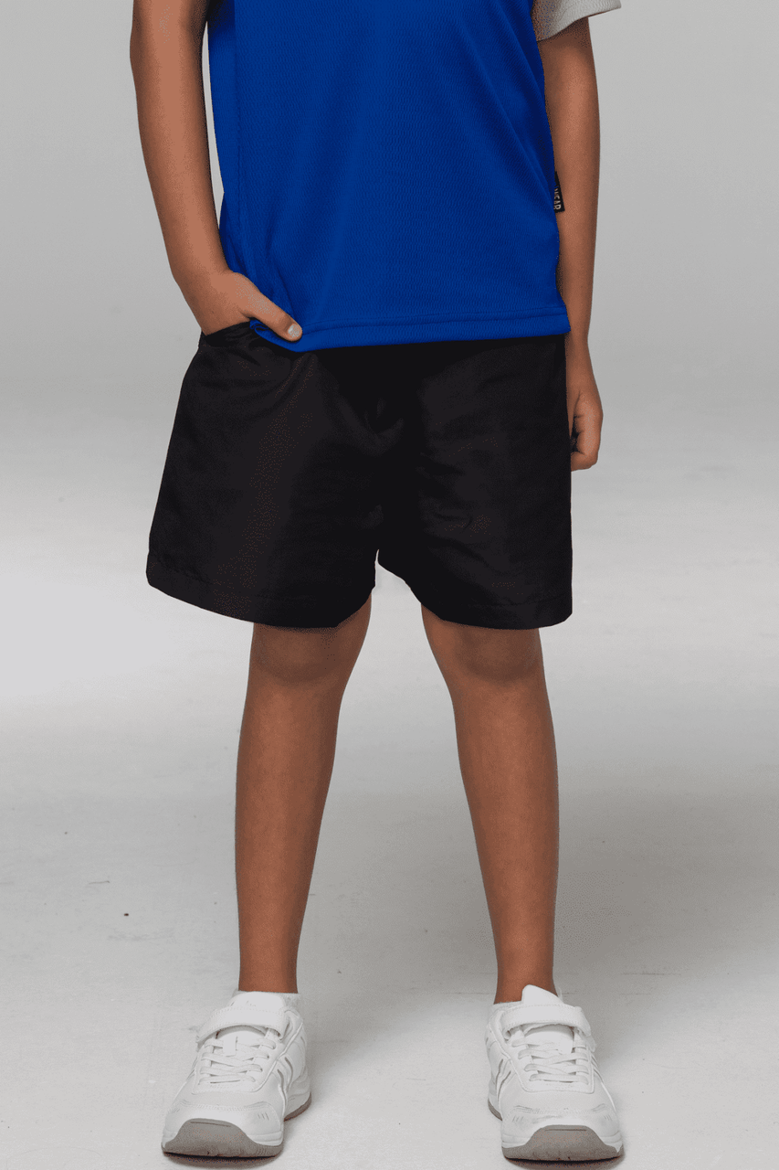 Black sports shorts for kids, featuring a relaxed fit and an elastic waistband, paired with a blue shirt.