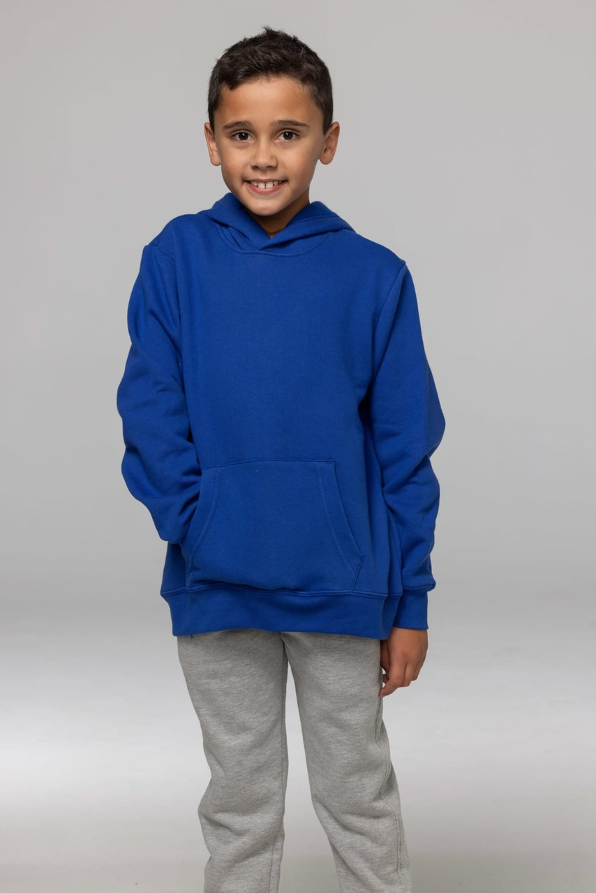 A child in a blue hoodie with a front pocket, wearing grey pants, posing against a neutral background.