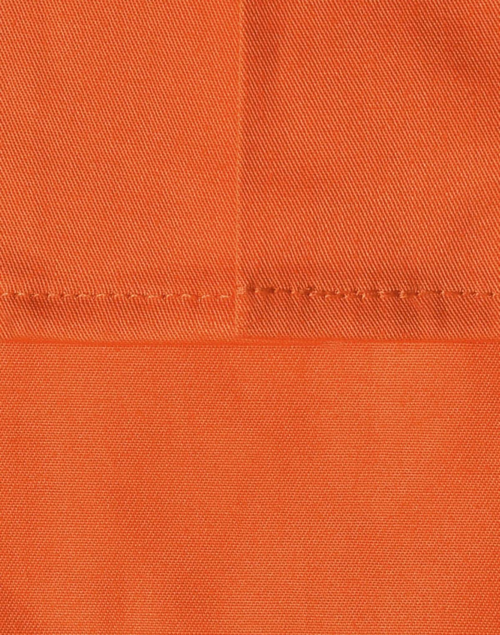 An orange fabric swatch featuring a close-up of stitching details, ideal for workwear applications.