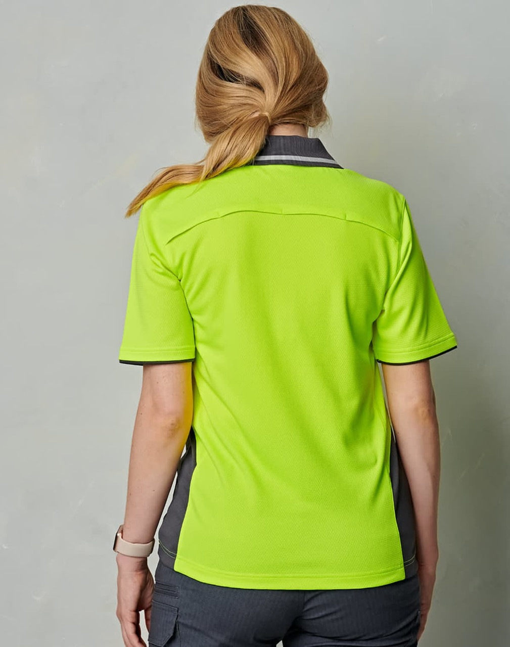 A hi-vis short-sleeve polo shirt in bright lime green with grey accents, featuring a logo on the collar.