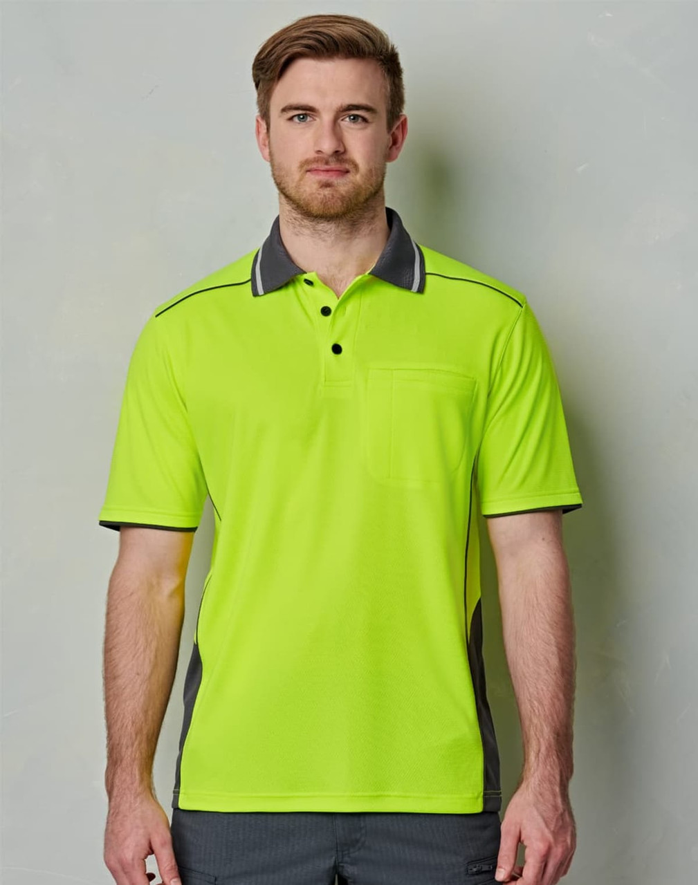 A high-visibility lime green polo shirt with grey accents and a chest pocket, featuring a logo on the front.