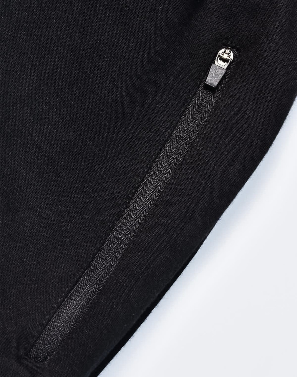 A pair of black poly/cotton terry sweat pants featuring a zip pocket and a soft texture.