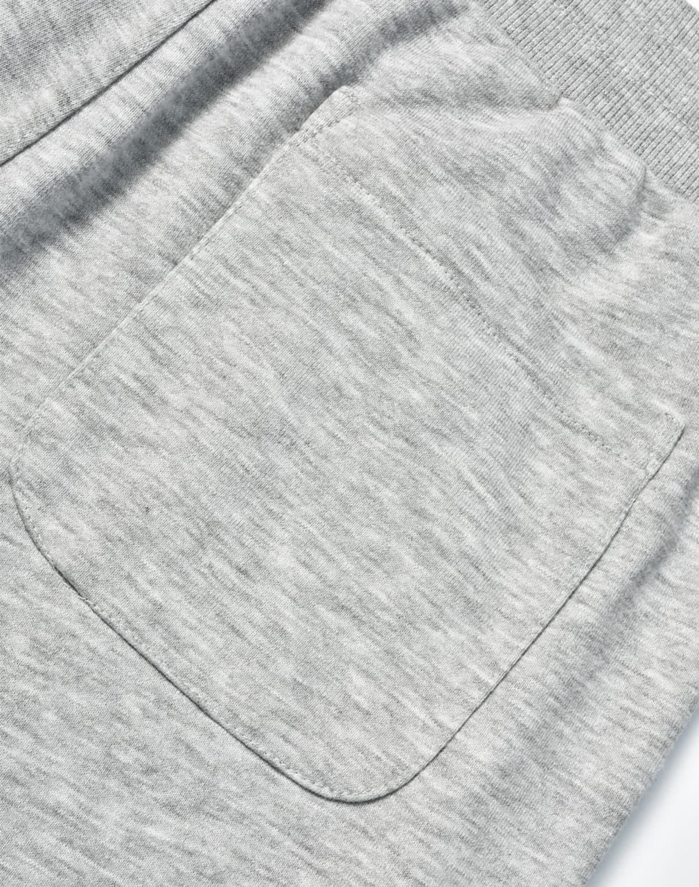 A close-up of grey poly/cotton terry sweat pants featuring a single back pocket and elastic waistband.