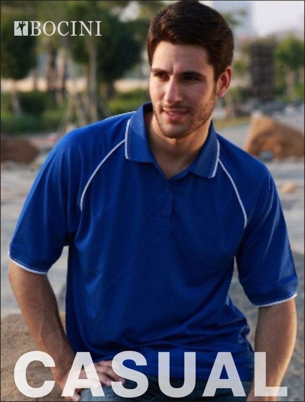 A blue unisex polo shirt with contrasting trim, featuring a logo, shown on a model in an outdoor setting.