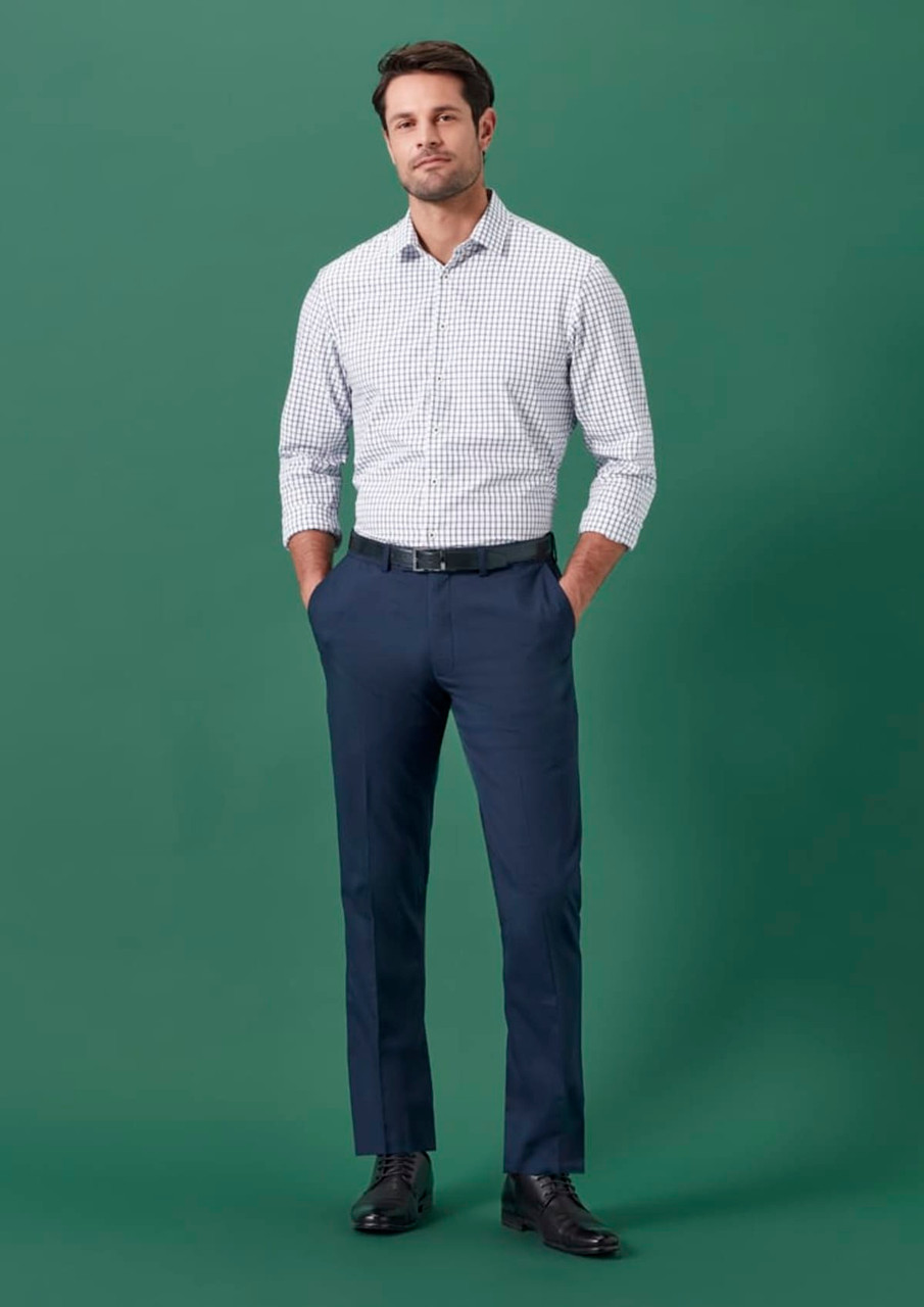 Men's adjustable waist straight leg pants in navy, paired with a checkered shirt. The model stands against a green background.