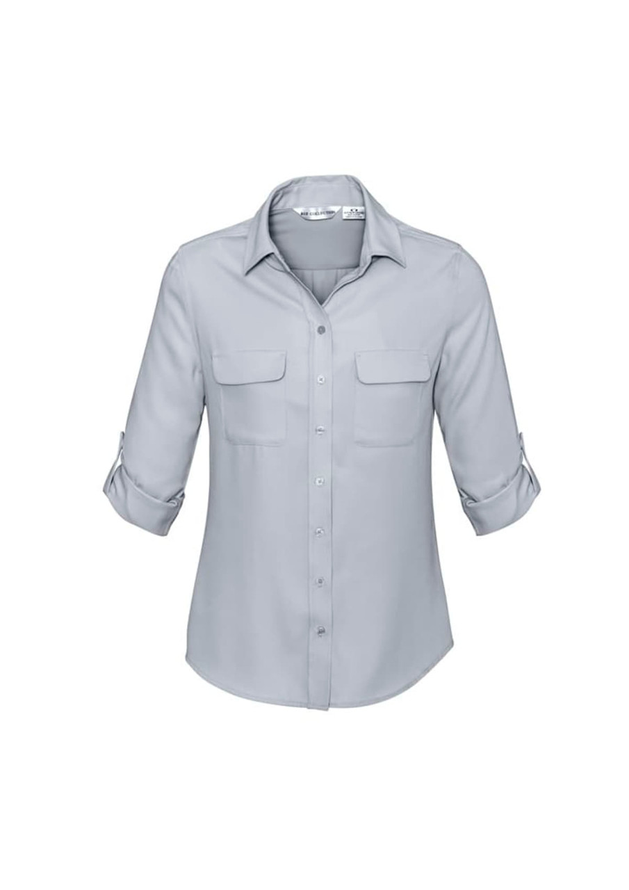 A light grey women's button-up long sleeve shirt with two chest pockets and rolled-up sleeves.