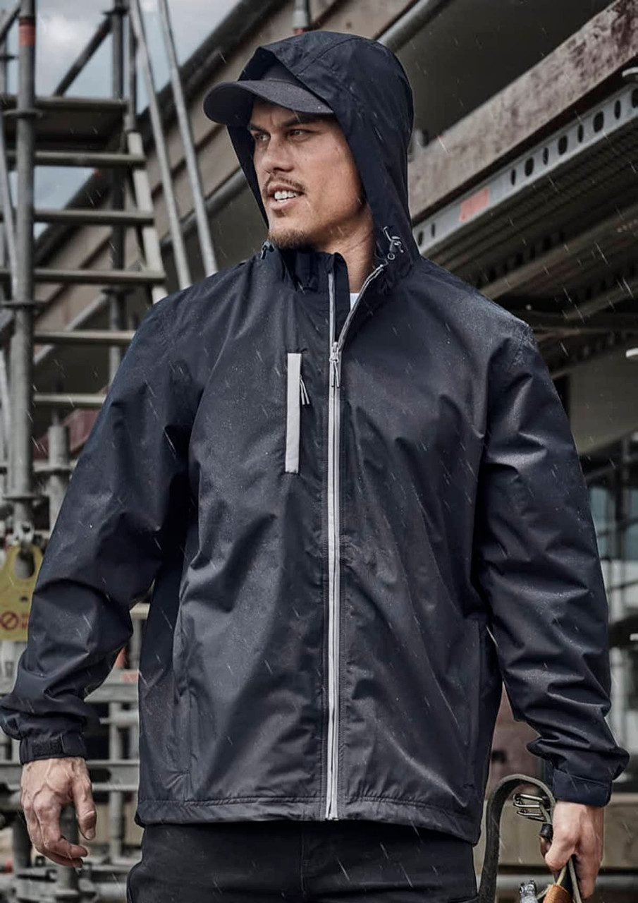 A unisex super light packable rain jacket in black, featuring a hood and zippered pocket, against a construction backdrop.