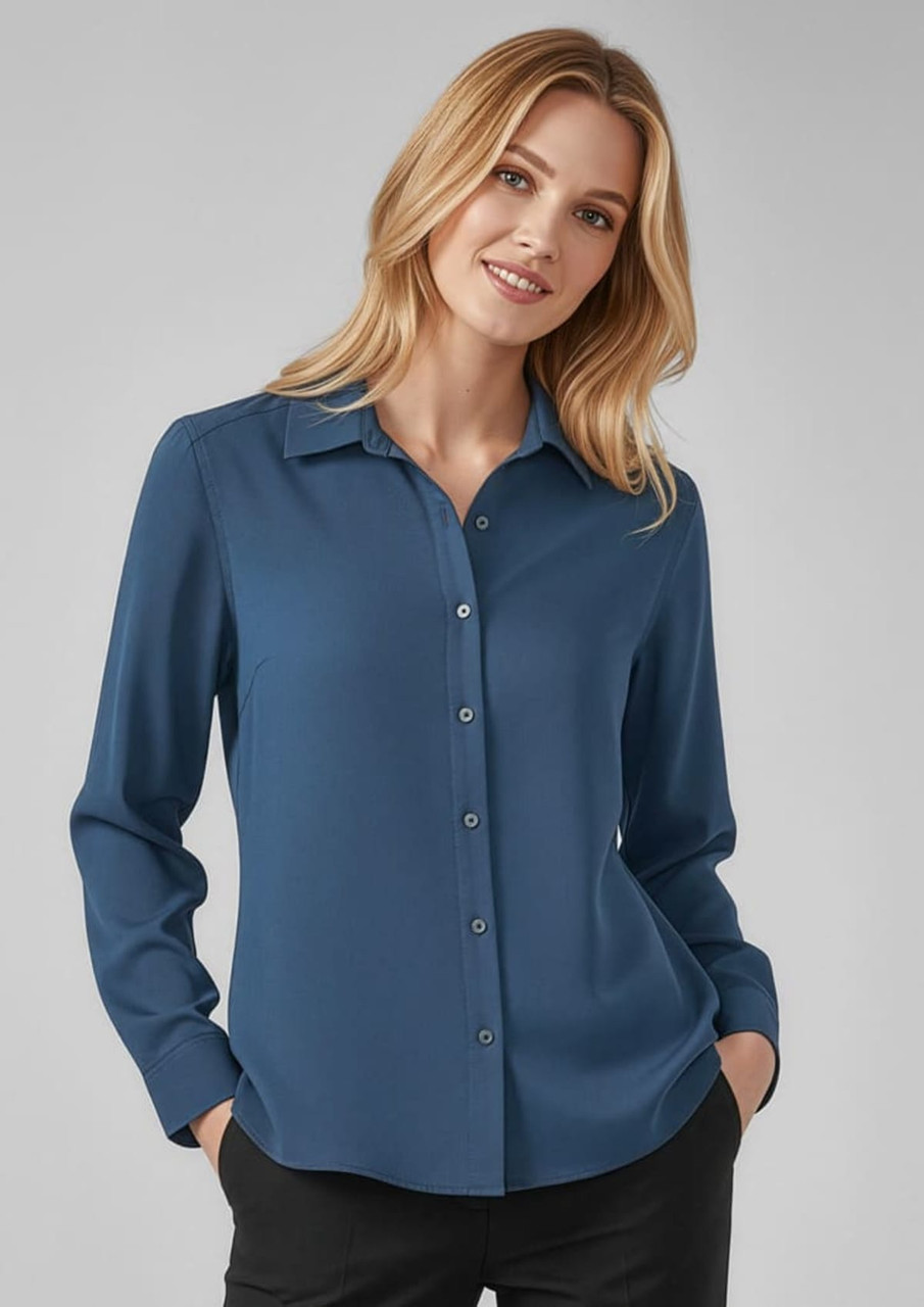 A women's long sleeve button-up shirt in a soft blue shade featuring a collar and front buttons.