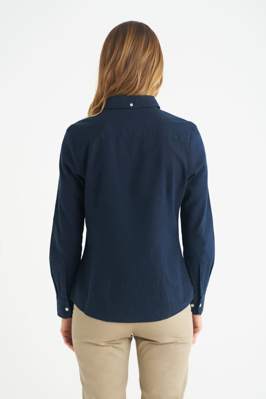 A navy blue ladies long sleeve button-up shirt with a fitted design and a collar. It has a logo on the back.