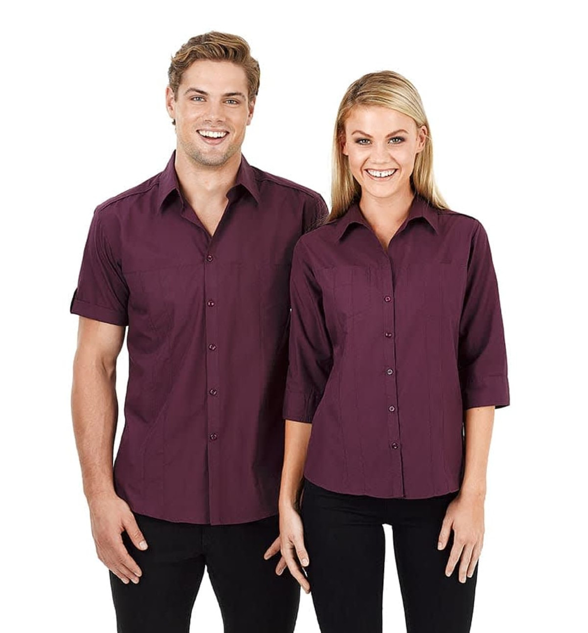 A dark burgundy button-up shirt in short sleeves for men, paired with a similar style for women. Both feature a logo.