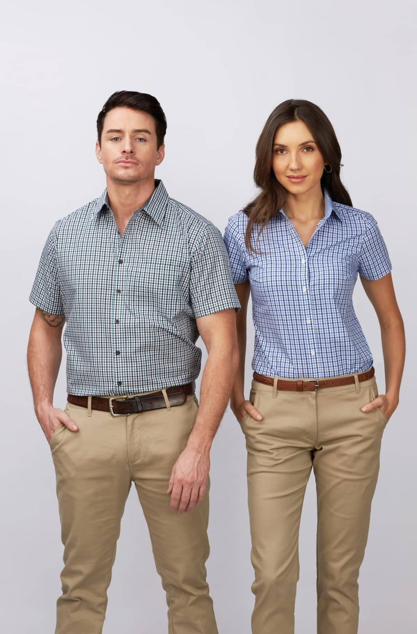 A short sleeve button-up shirt in blue and white check pattern worn by a man and woman, paired with beige trousers.