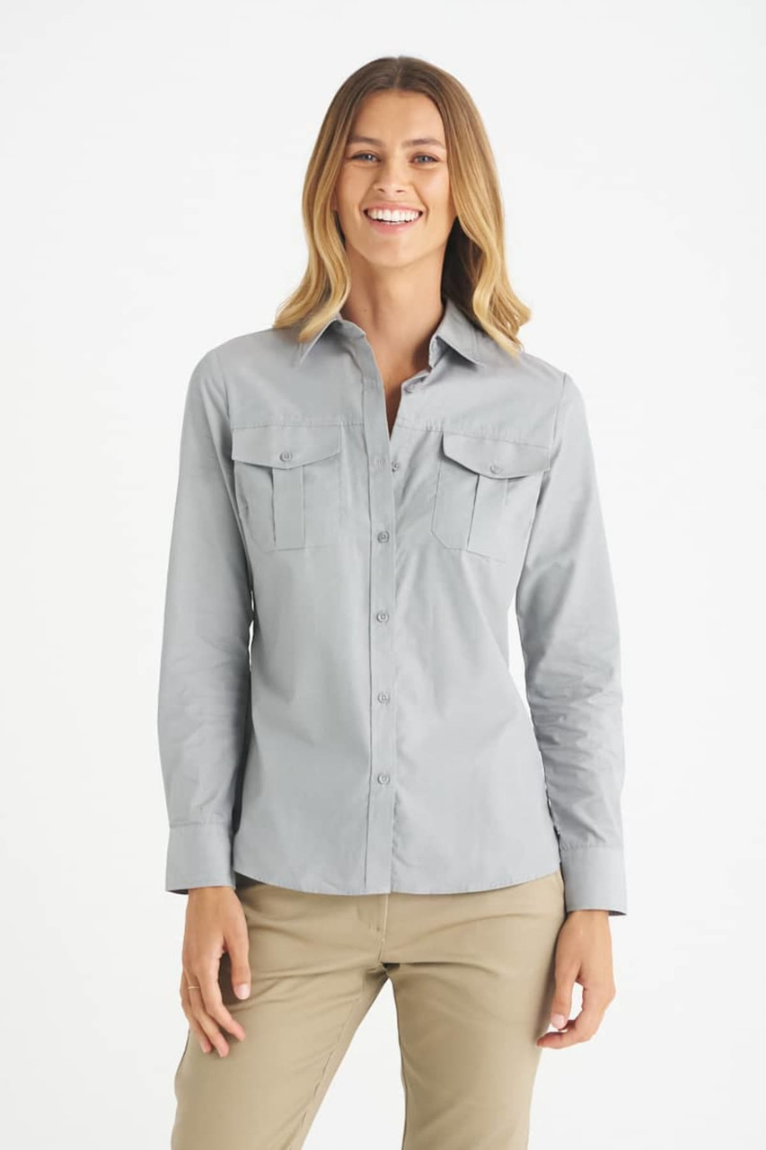 A light grey button-up shirt with two front pockets, designed for women, featured on a model.