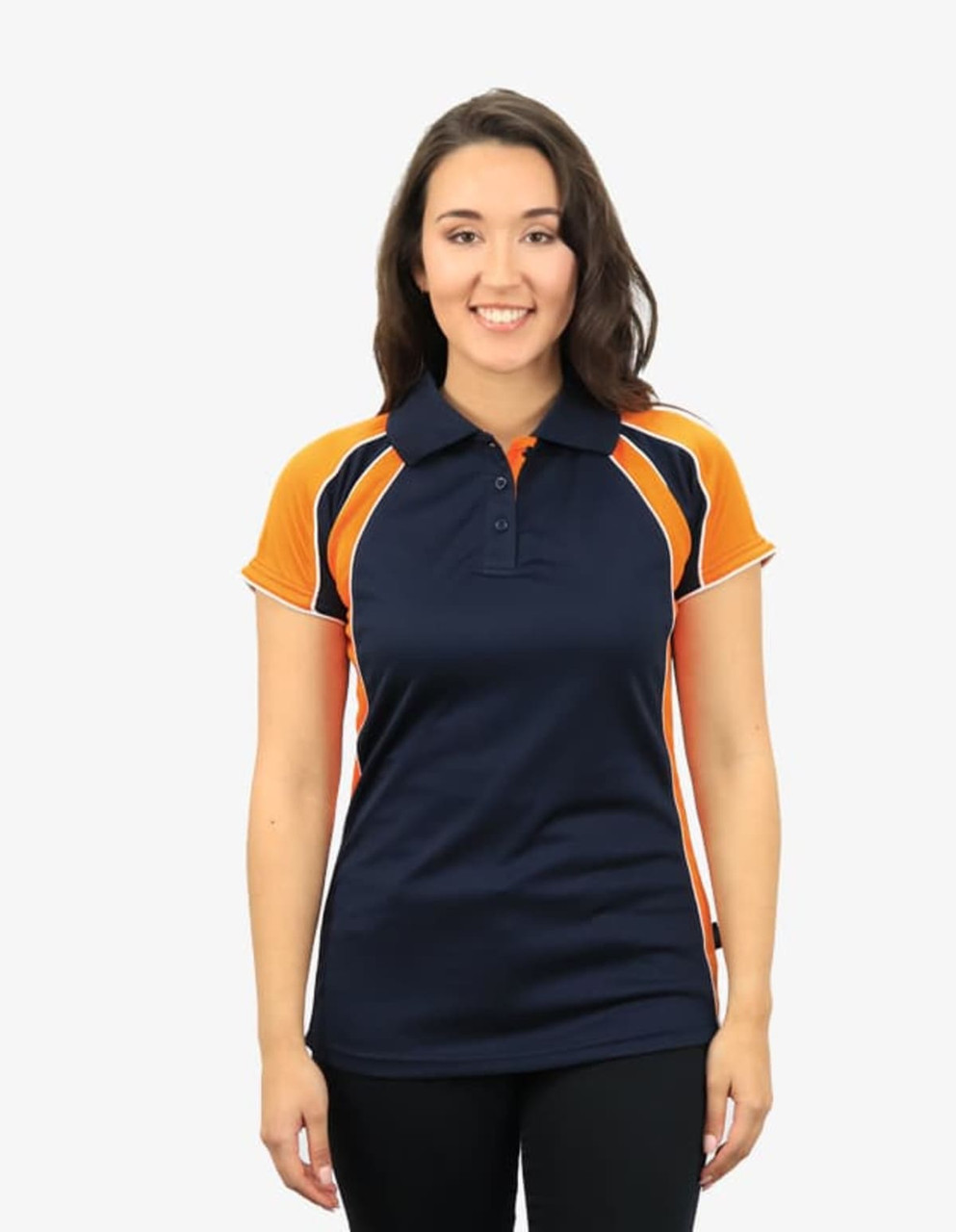 A navy and orange polo shirt featuring a logo, modelled by a smiling woman.