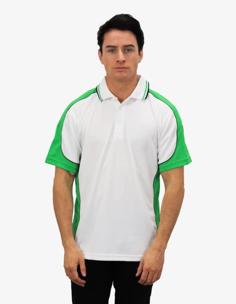 A polo shirt in white with green accents and a logo on the front. Model is wearing it while standing.