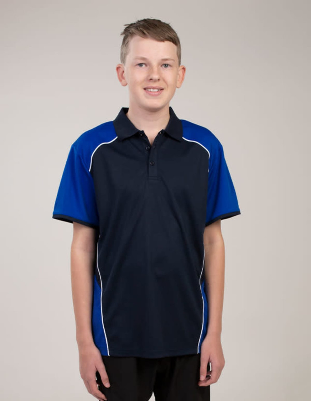 A navy and royal blue polo shirt featuring white piping, worn by a young male model. The shirt has a logo.